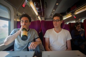 Gianmarco sips cider on the train.
